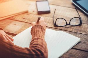 Person-writing-notebook-article.jpg