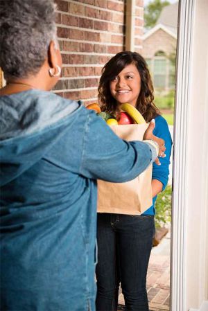 Teenage-girl-groceries-senior-woman-home-article.jpg