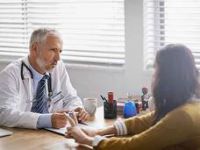 Seated-male-doctor-advising-woman-article.jpg