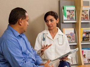 Hispanic-female-doctor-talks to-hispanic-male-patient-in-waiting-room-article.jpg