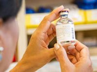 Pharmacist-examining-drug-vial-feature-card.jpg